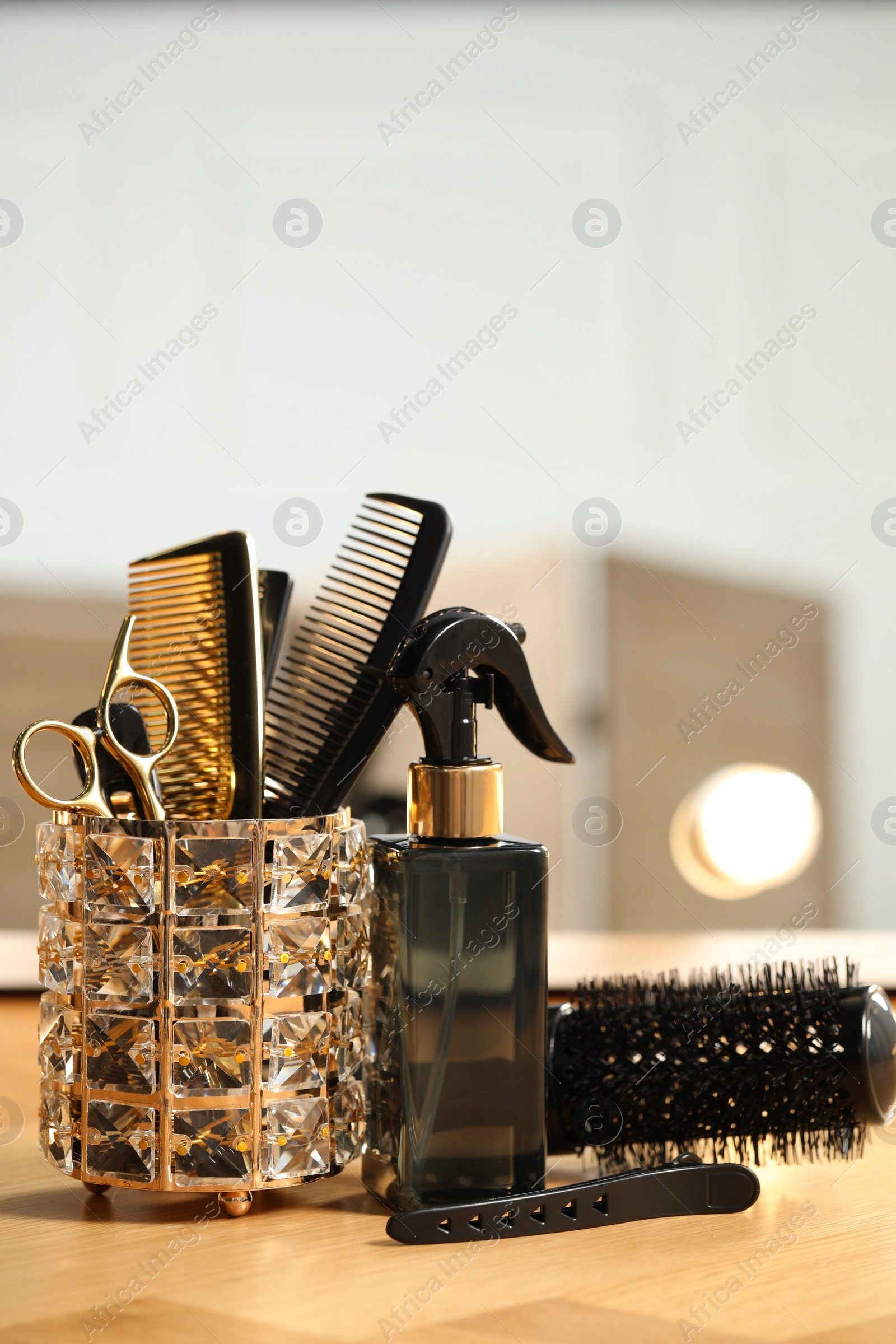 Photo of Set of hairdresser tools on table in salon