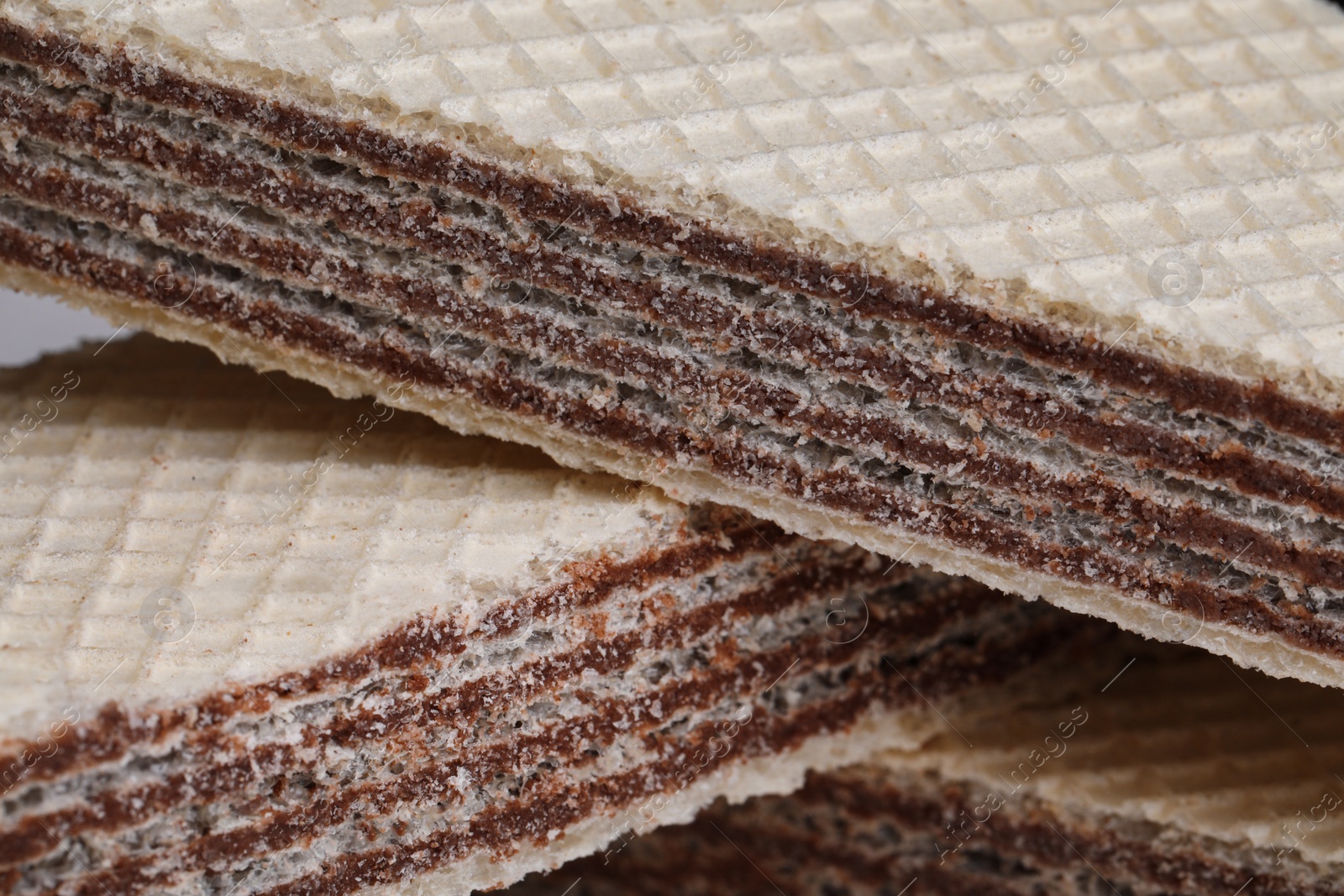 Photo of Delicious crispy wafers with chocolate filling as background, closeup view