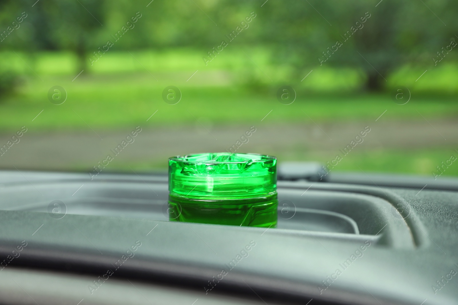 Photo of Stylish air freshener on dashboard in car