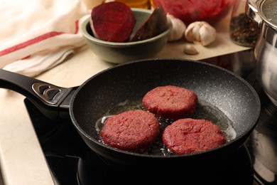 Photo of Cooking vegan cutlets in frying pan on stove