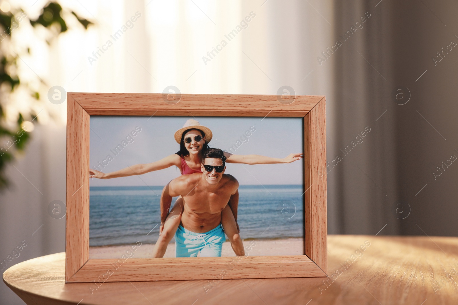 Photo of Framed photo of happy couple on wooden table in room