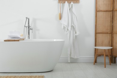 Photo of Stylish bathroom interior with modern white tub