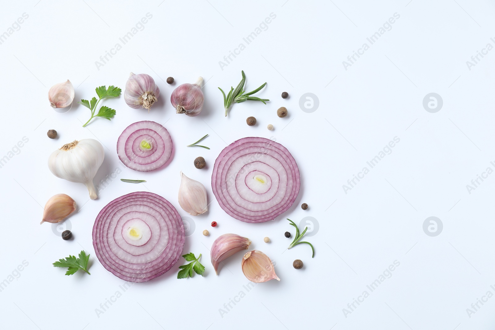 Photo of Fresh garlic, onion rings and spices on white table, flat lay. Space for text