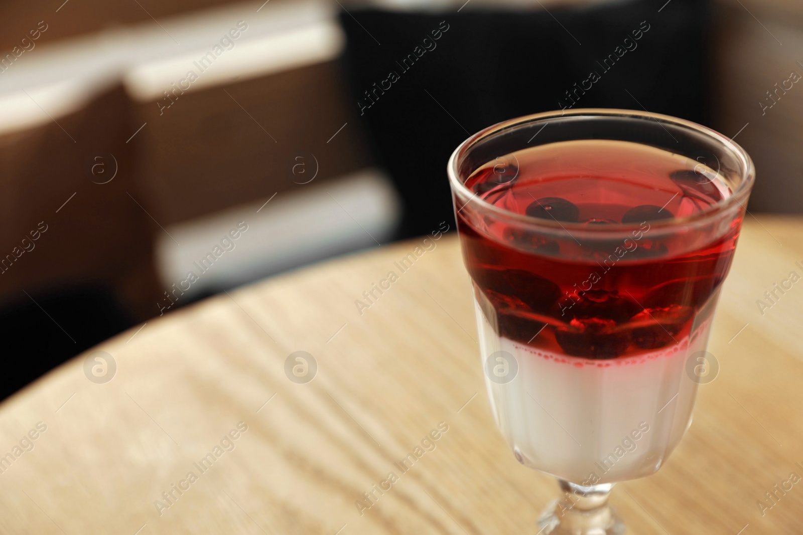 Photo of Delicious panna cotta dessert on wooden table, closeup. Space for text