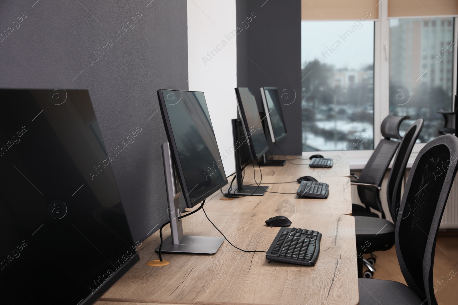 Photo of Many modern computers in open space office