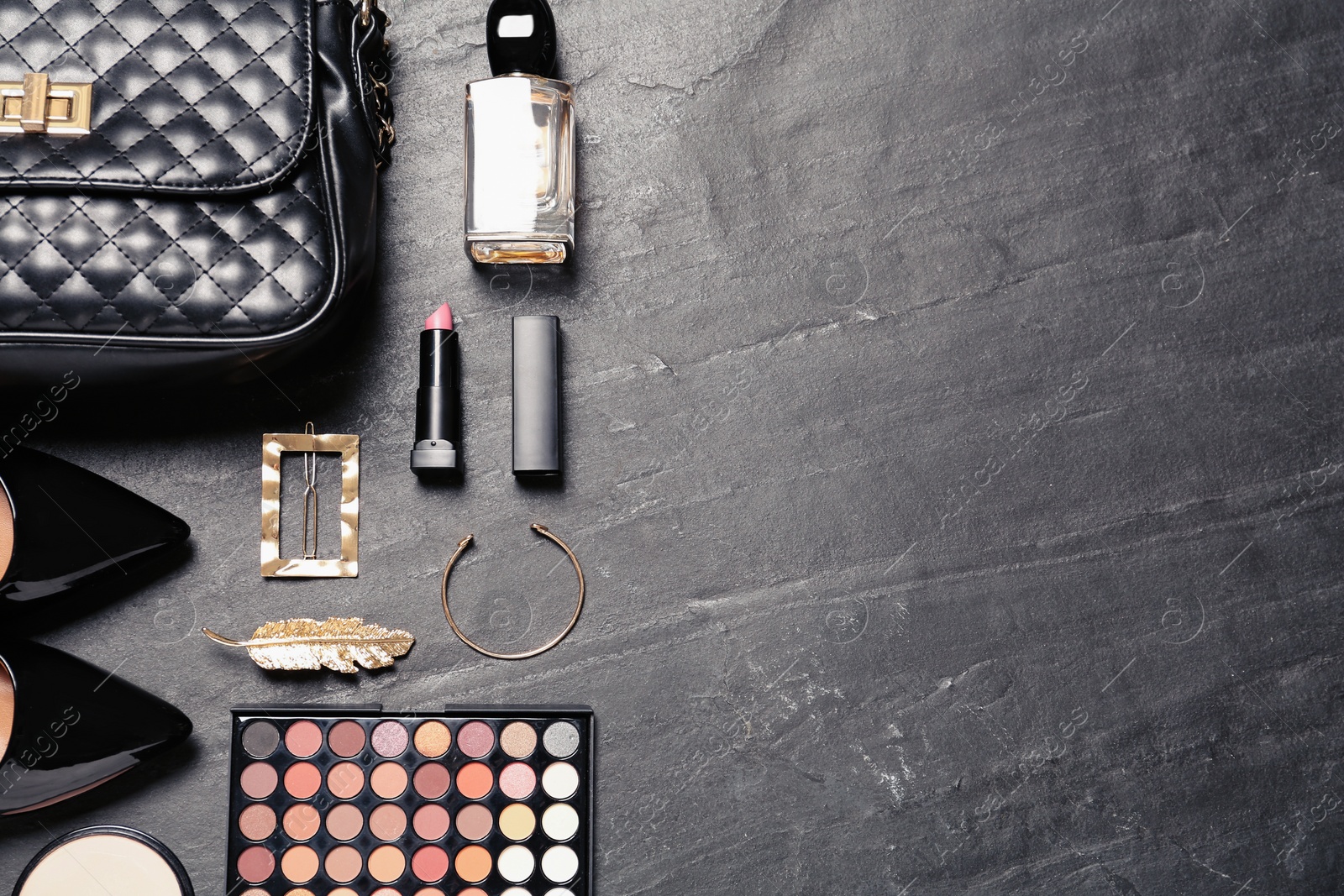 Photo of Flat lay composition with stylish women's shoes and cosmetic products on black background. Space for text