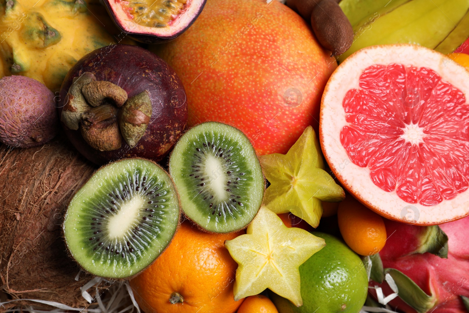 Photo of Different tropical fruits as background, closeup view