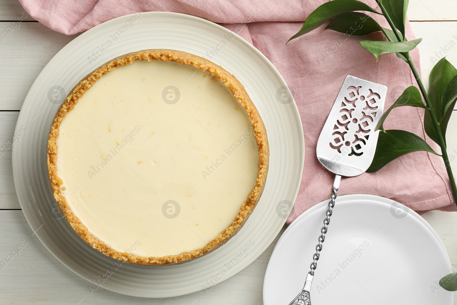 Photo of Tasty vegan tofu cheesecake served on white wooden table, flat lay