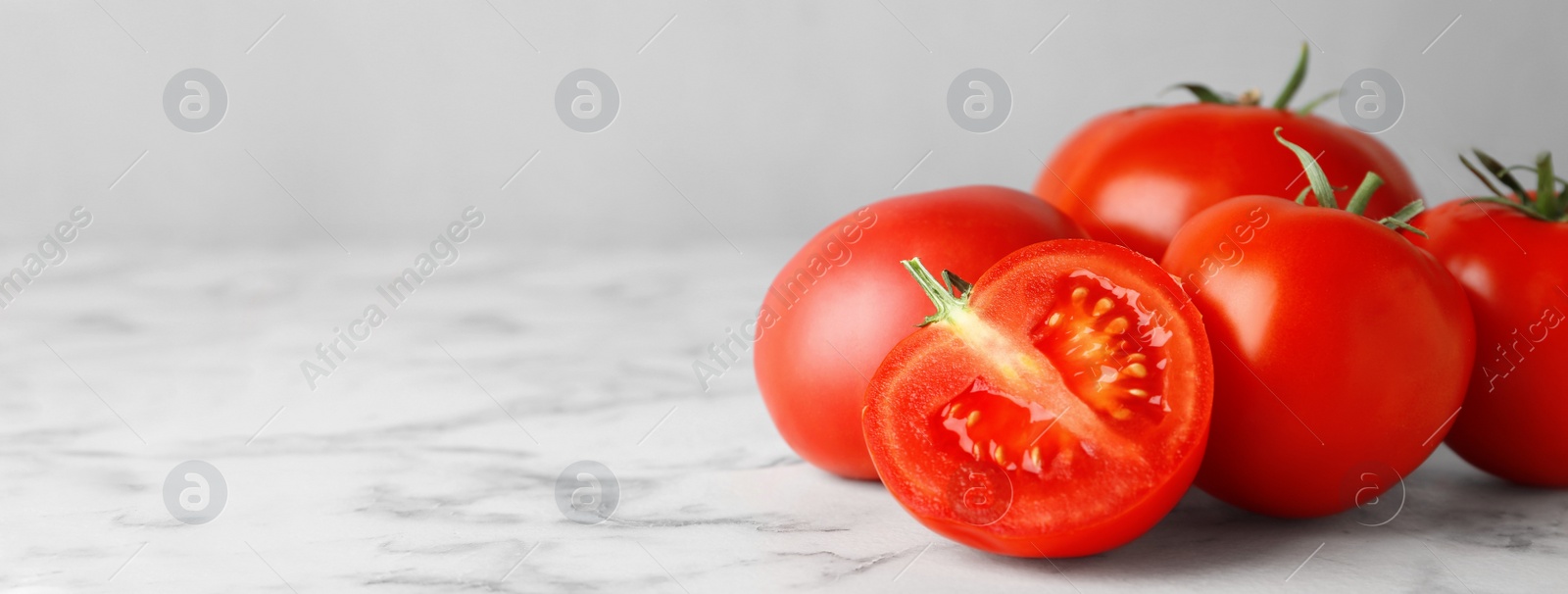 Image of Composition with fresh cherry tomatoes on marble table, space for text. Banner design 