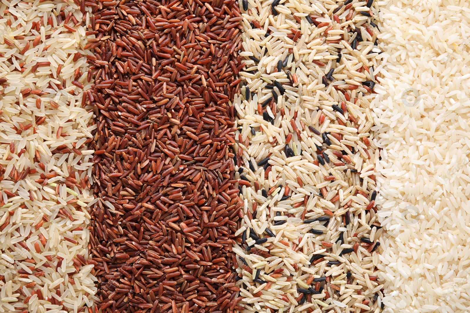 Photo of Different types of rice as background, top view