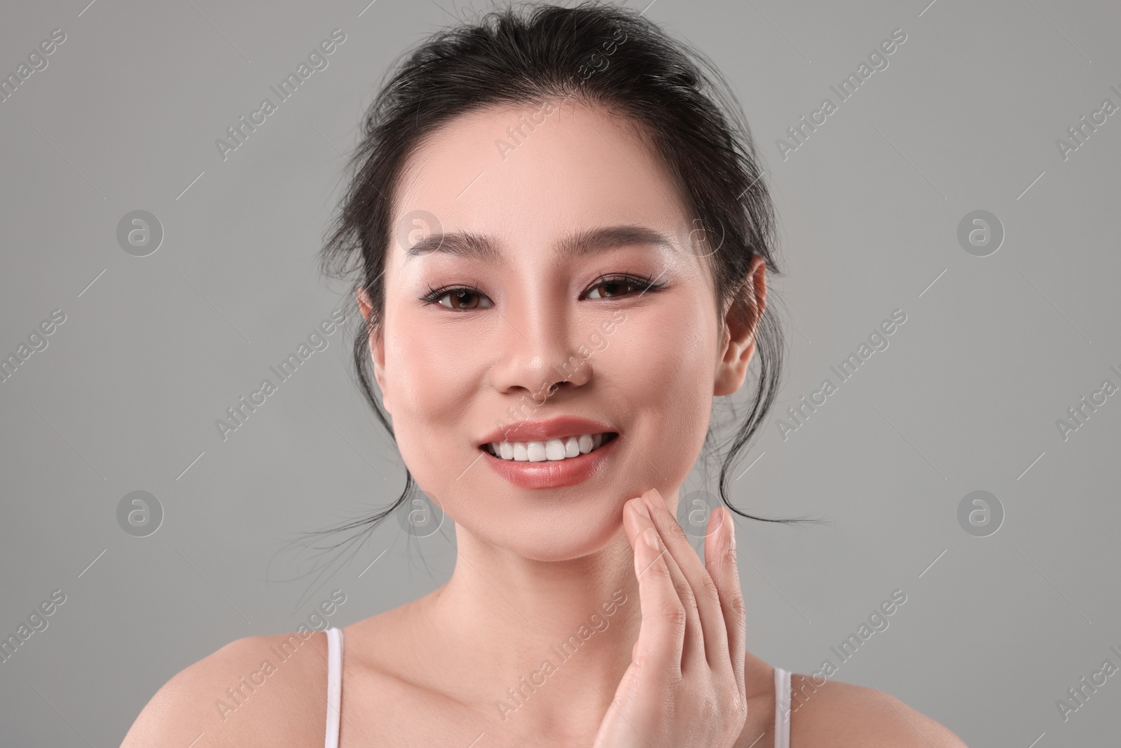 Photo of Portrait of beautiful woman on grey background