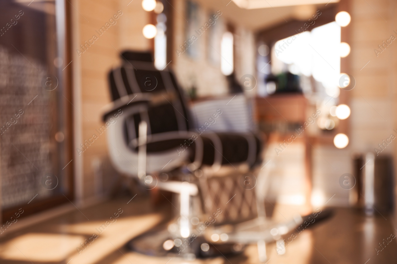 Photo of Blurred view of stylish barbershop interior with hairdresser workplace