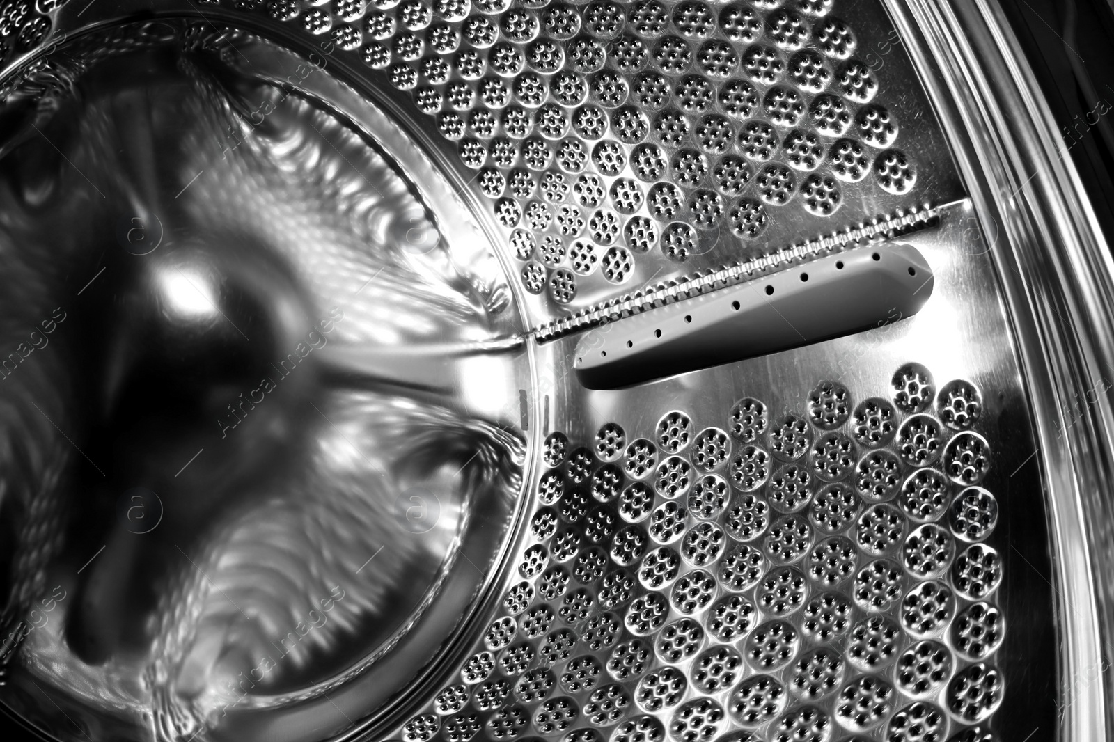 Photo of Empty washing machine drum, closeup view. Laundry day