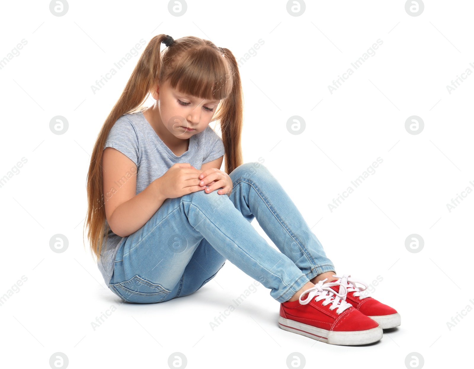 Photo of Full length portrait of little girl with knee problems sitting on white background