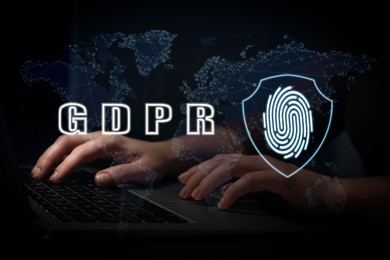 Image of General Data Protection Regulation. Woman working with laptop on black background, closeup. GDPR abbreviation, shield with fingerprint and world map