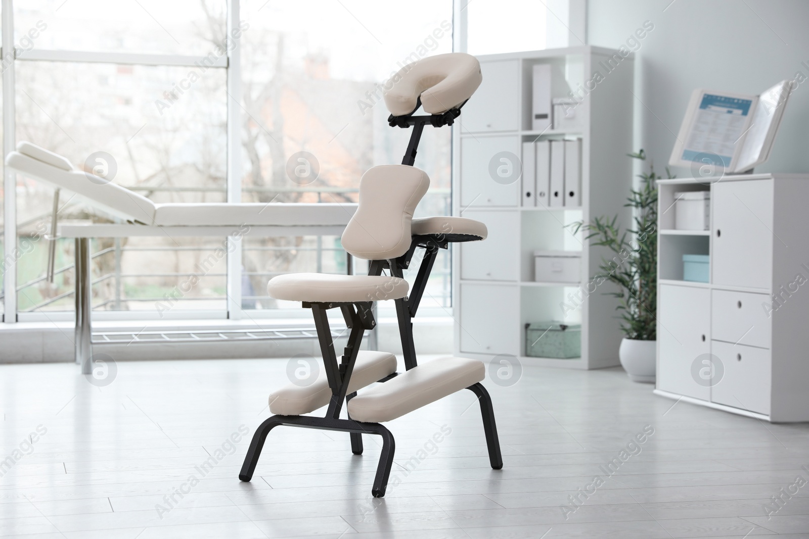 Photo of Modern massage chair in clinic. Medical equipment