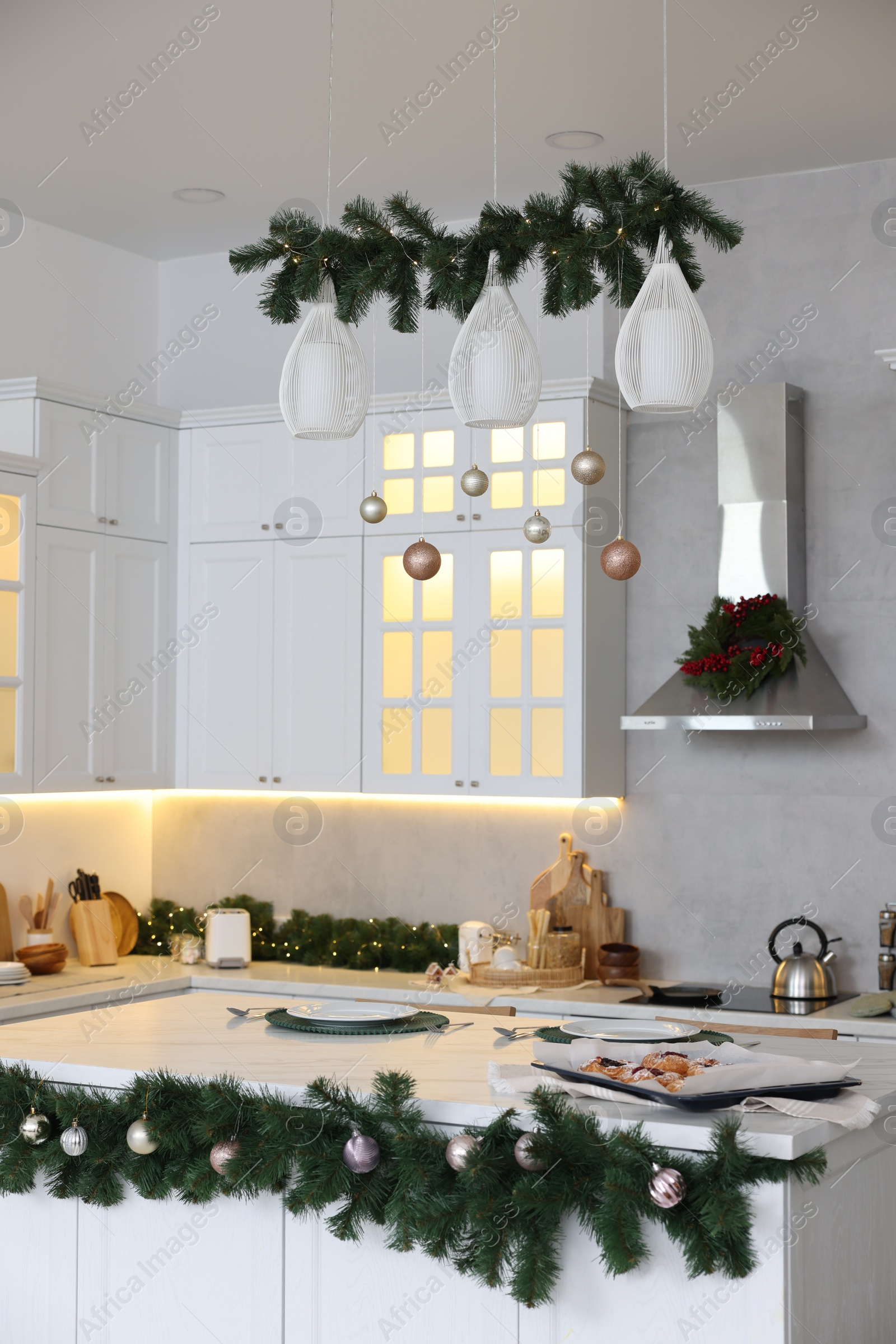 Photo of Cozy spacious kitchen decorated for Christmas. Interior design