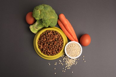 Photo of Dry pet food and products on black background, flat lay