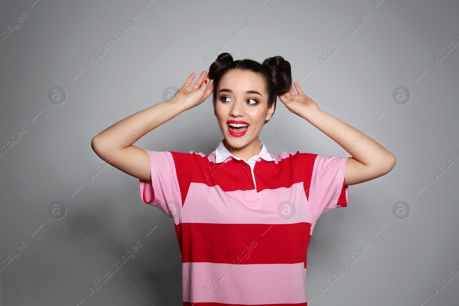 Photo of Portrait of beautiful young woman on grey background