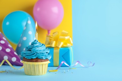 Delicious birthday cupcake with candle on color background, space for text