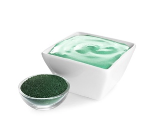 Freshly made spirulina facial mask in bowl and powder on white background