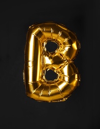 Golden letter B balloon on black background