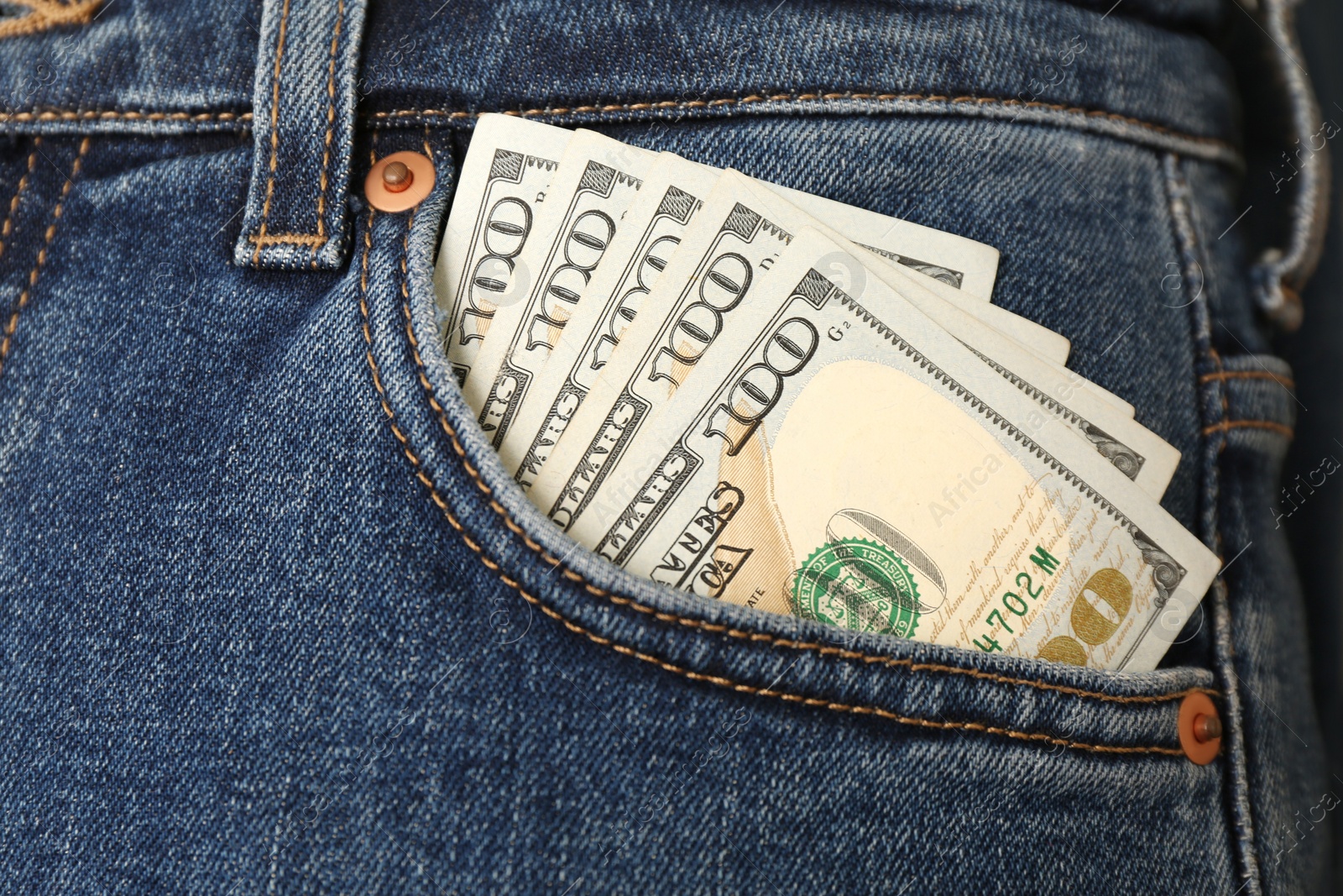 Photo of Dollar banknotes in pocket of jeans, closeup. Spending money