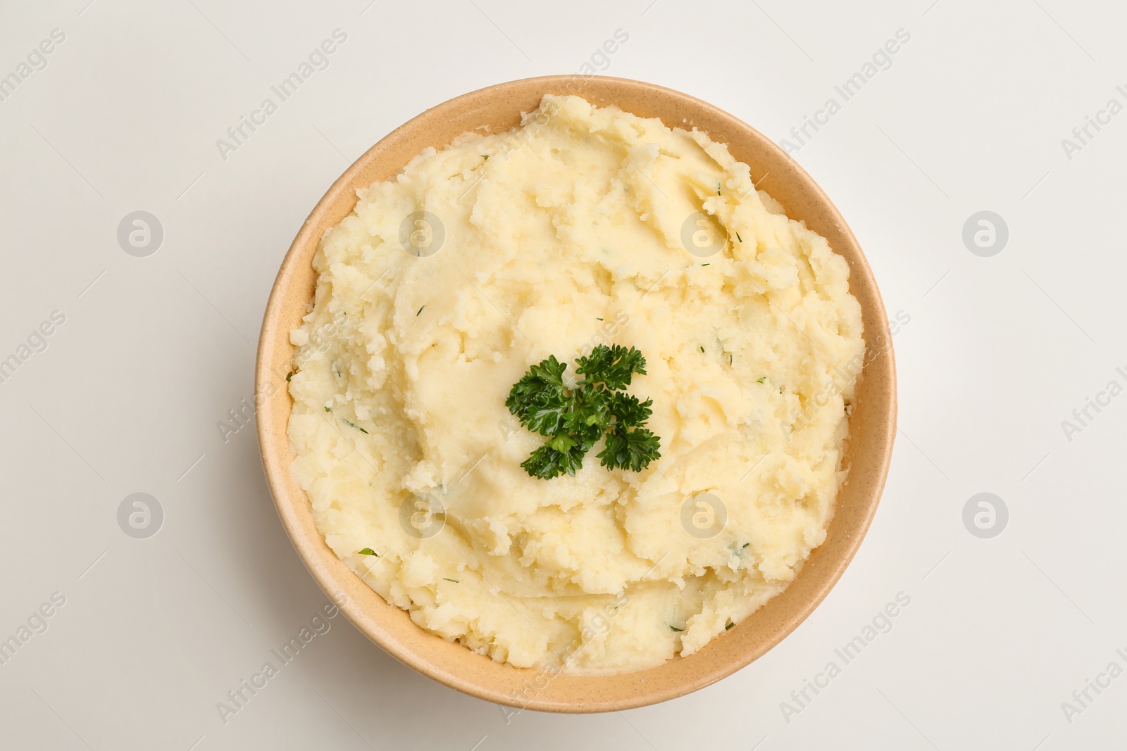 Photo of Bowl with tasty mashed potato on white background, top view