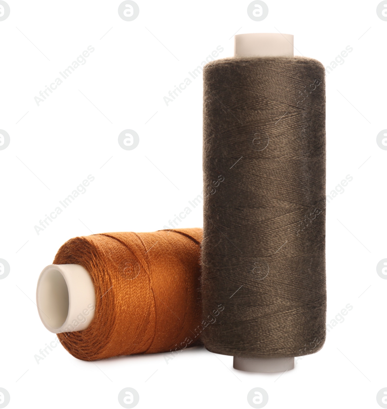 Photo of Different colorful sewing threads on white background