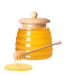 Natural honey dripping from dipper. Jar full of honey on white background