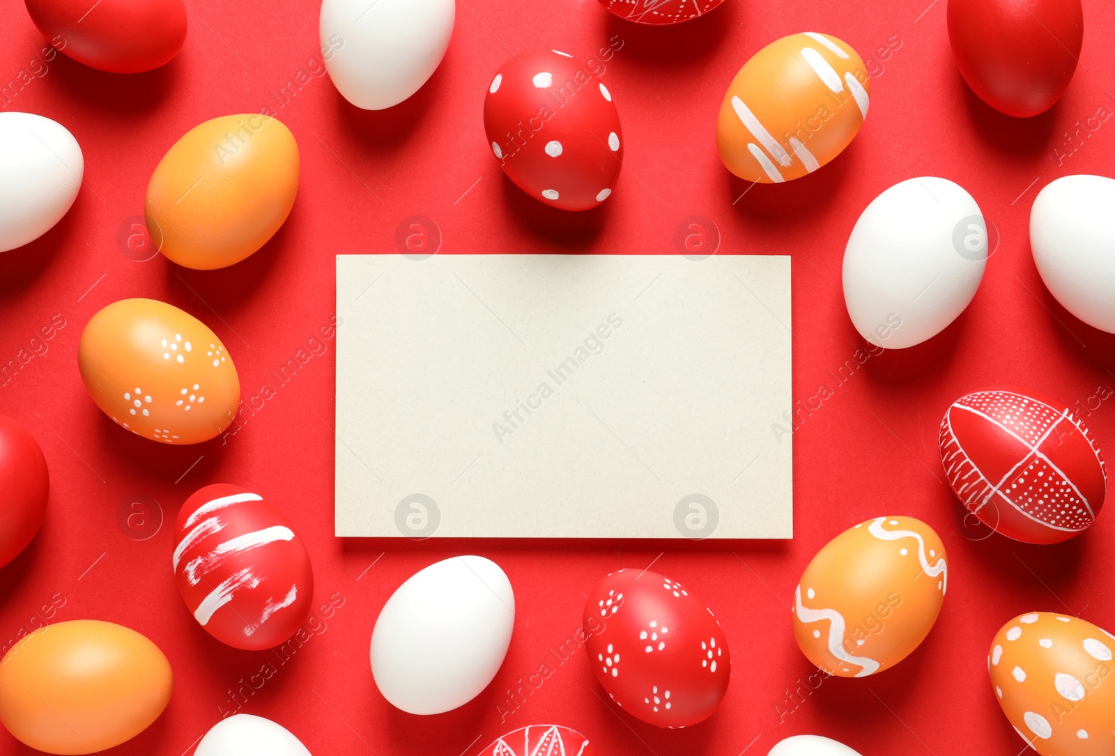 Photo of Flat lay composition of painted Easter eggs and card on color background, space for text