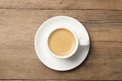 Photo of Aromatic coffee in cup on wooden table, top view