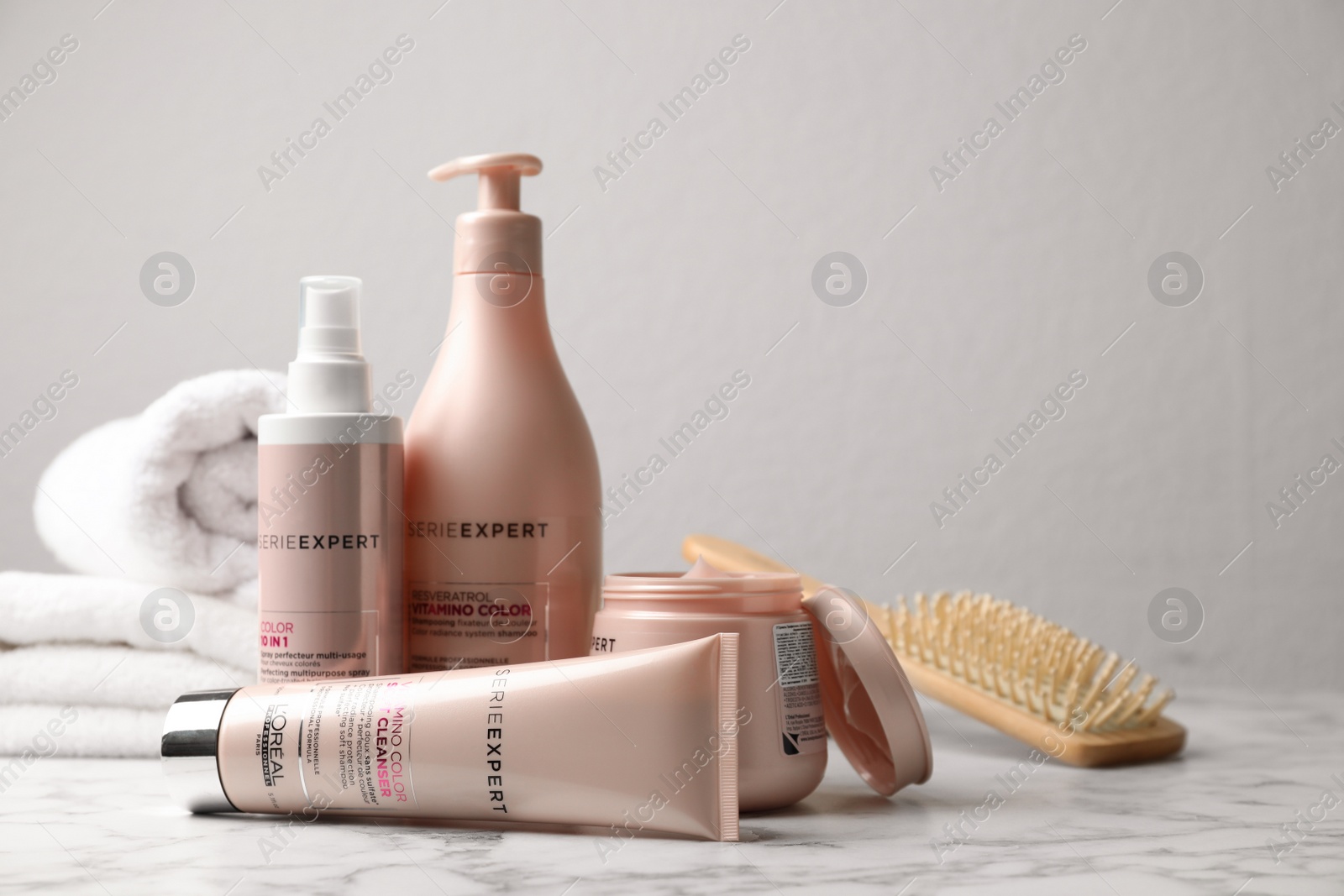 Photo of MYKOLAIV, UKRAINE - AUGUST 08, 2020: L'Oreal hair care cosmetic products on white marble table. Space for text