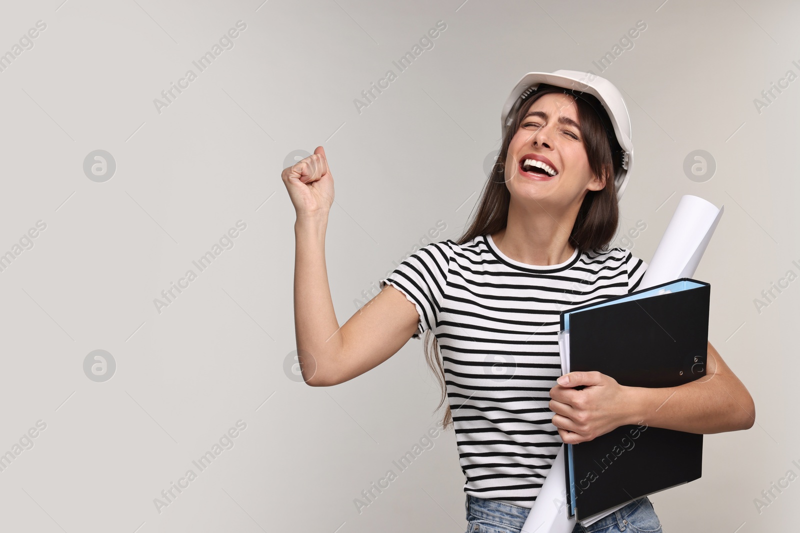 Photo of Architect in hard hat with draft and folder on light grey background, space for text