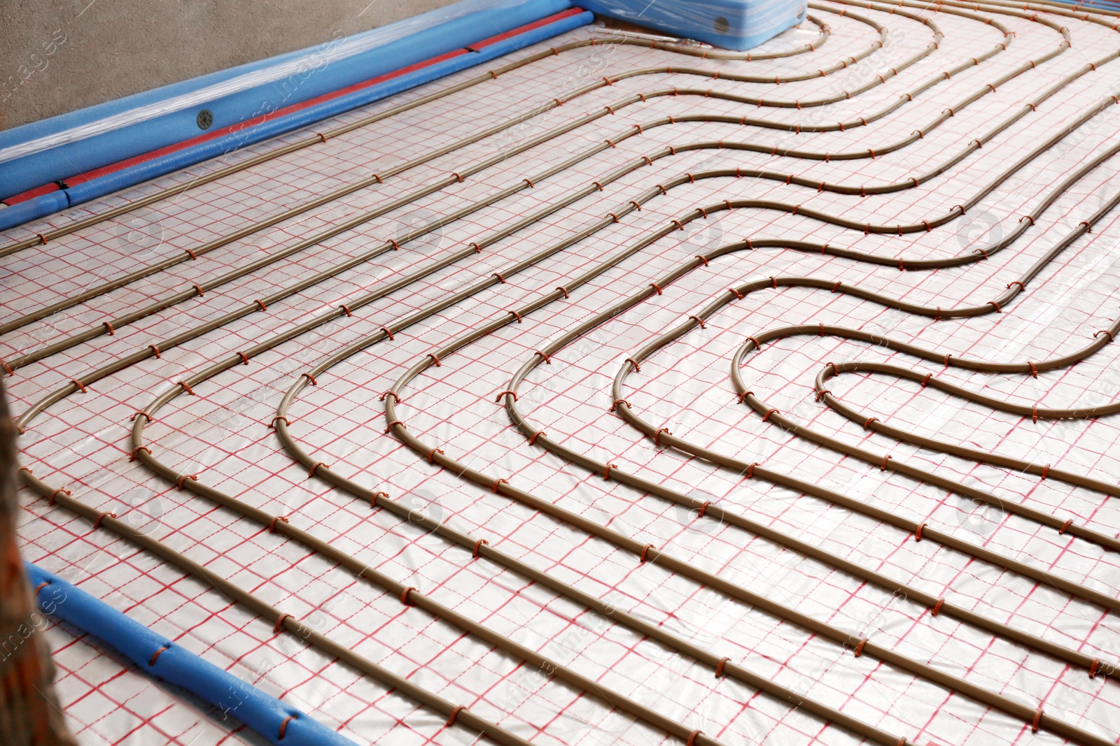 Photo of Installation of underfloor heating system in building