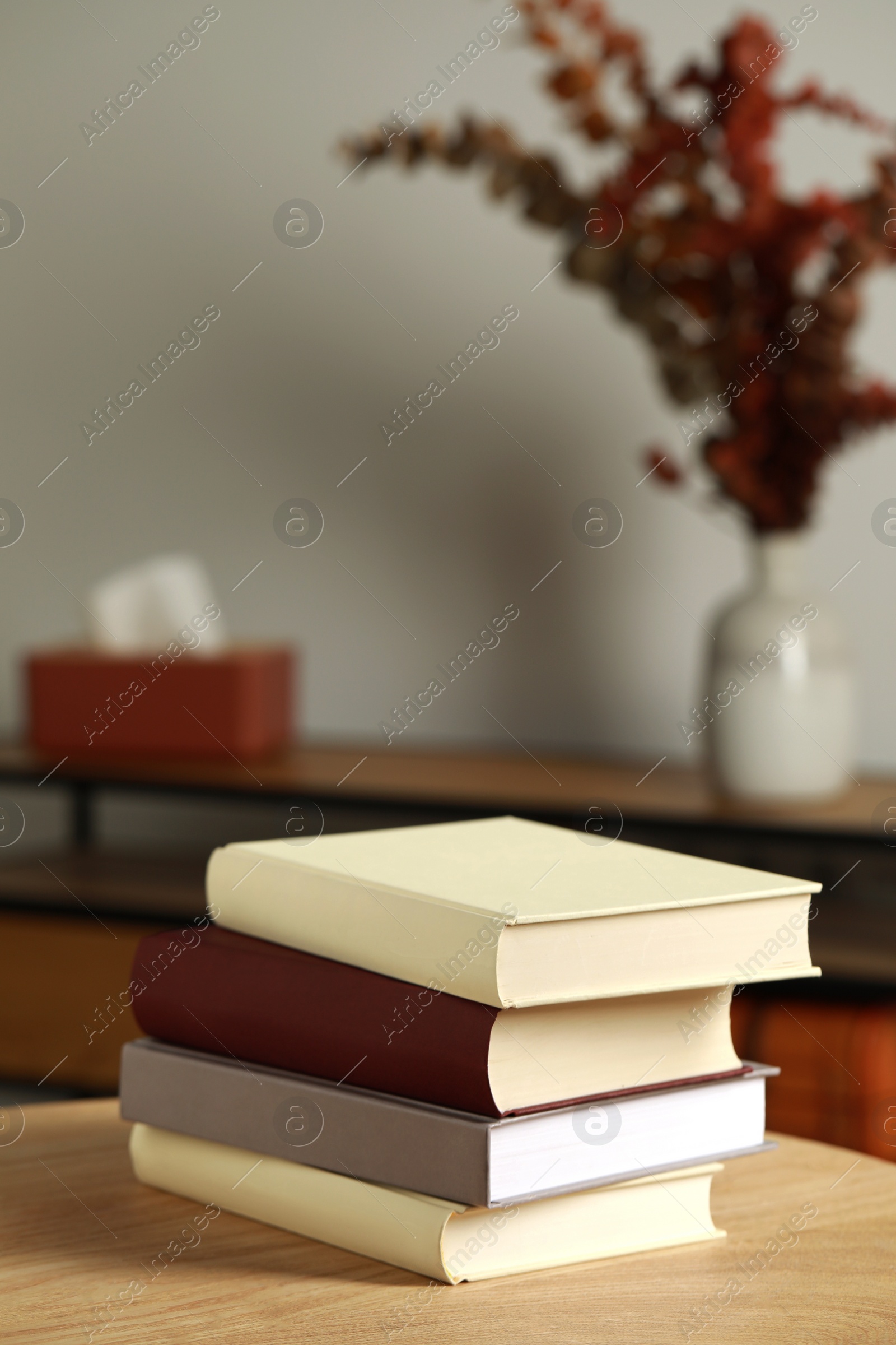 Photo of Many books stacked on wooden table indoors, space for text