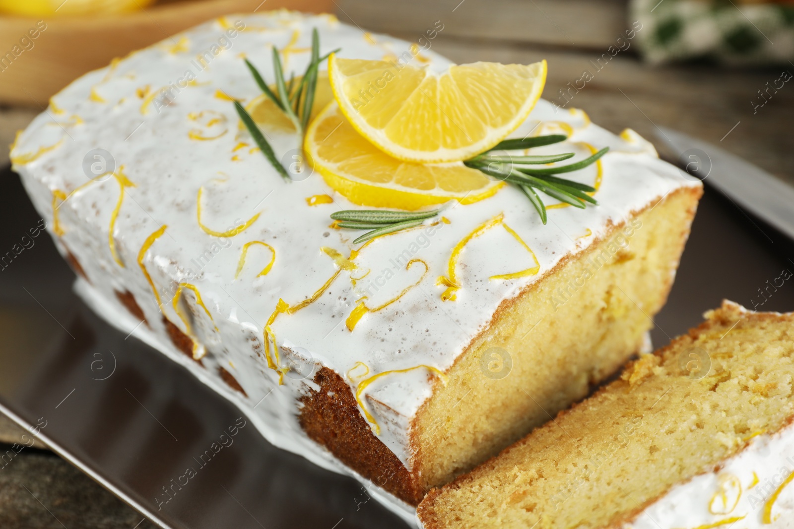 Photo of Tasty lemon cake with glaze on table, closeup