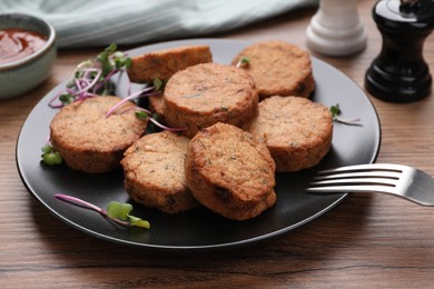 Photo of Delicious vegan cutlets served on wooden table, closeup