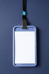 Photo of Blank badge with string on blue background, top view