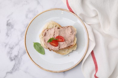 Photo of Delicious liverwurst sandwich with tomatoes and basil on white marble table, flat lay