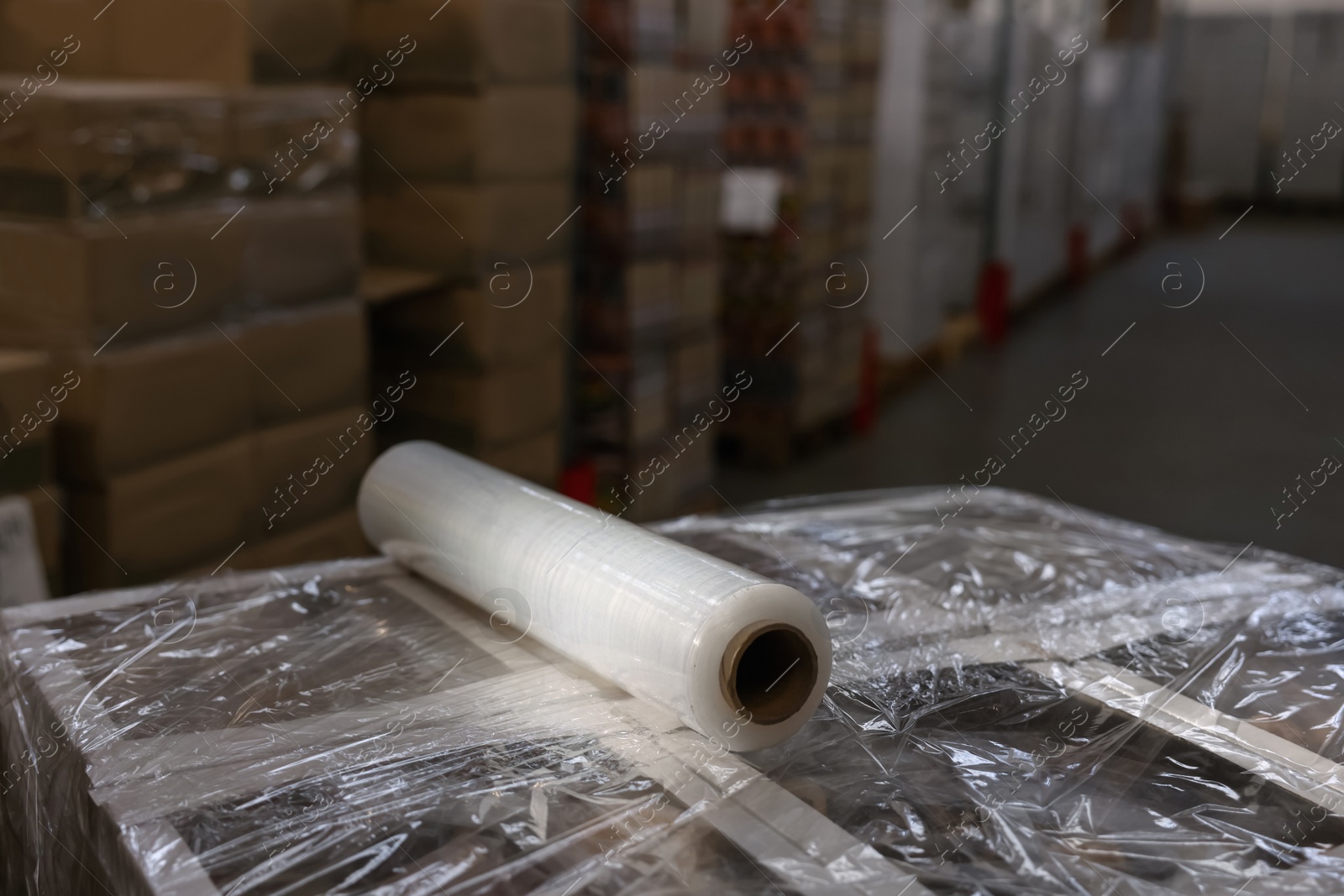 Photo of Roll of stretch wrap on box in warehouse