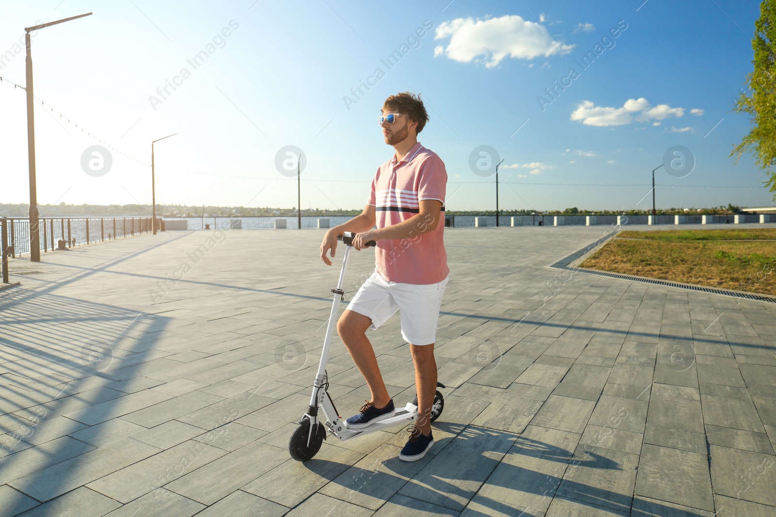 Photo of Man with modern kick scooter on waterfront