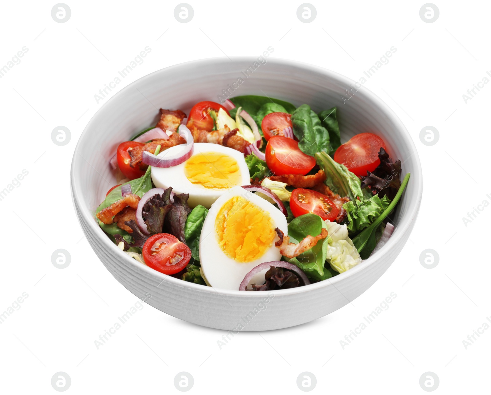 Photo of Delicious salad with boiled egg, bacon and vegetables in bowl isolated on white