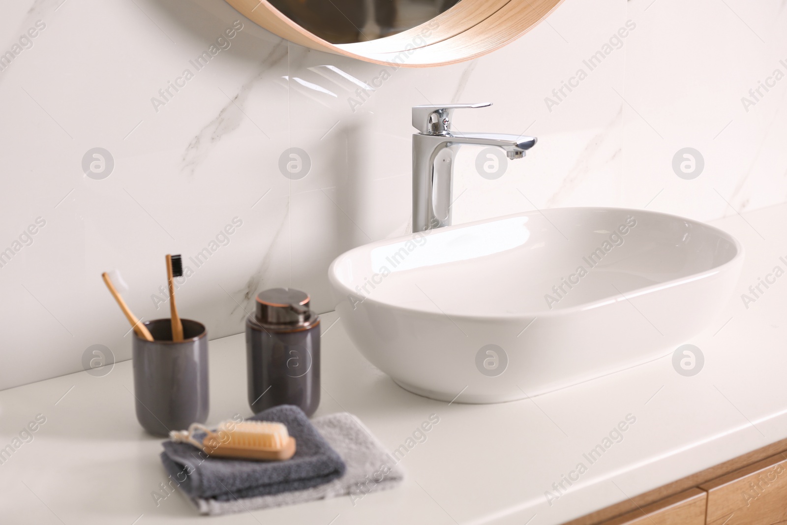 Photo of Stylish vessel sink on light countertop in modern bathroom