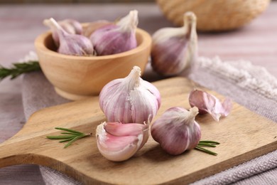 Photo of Bulbs and cloves of fresh garlic on table, closeup