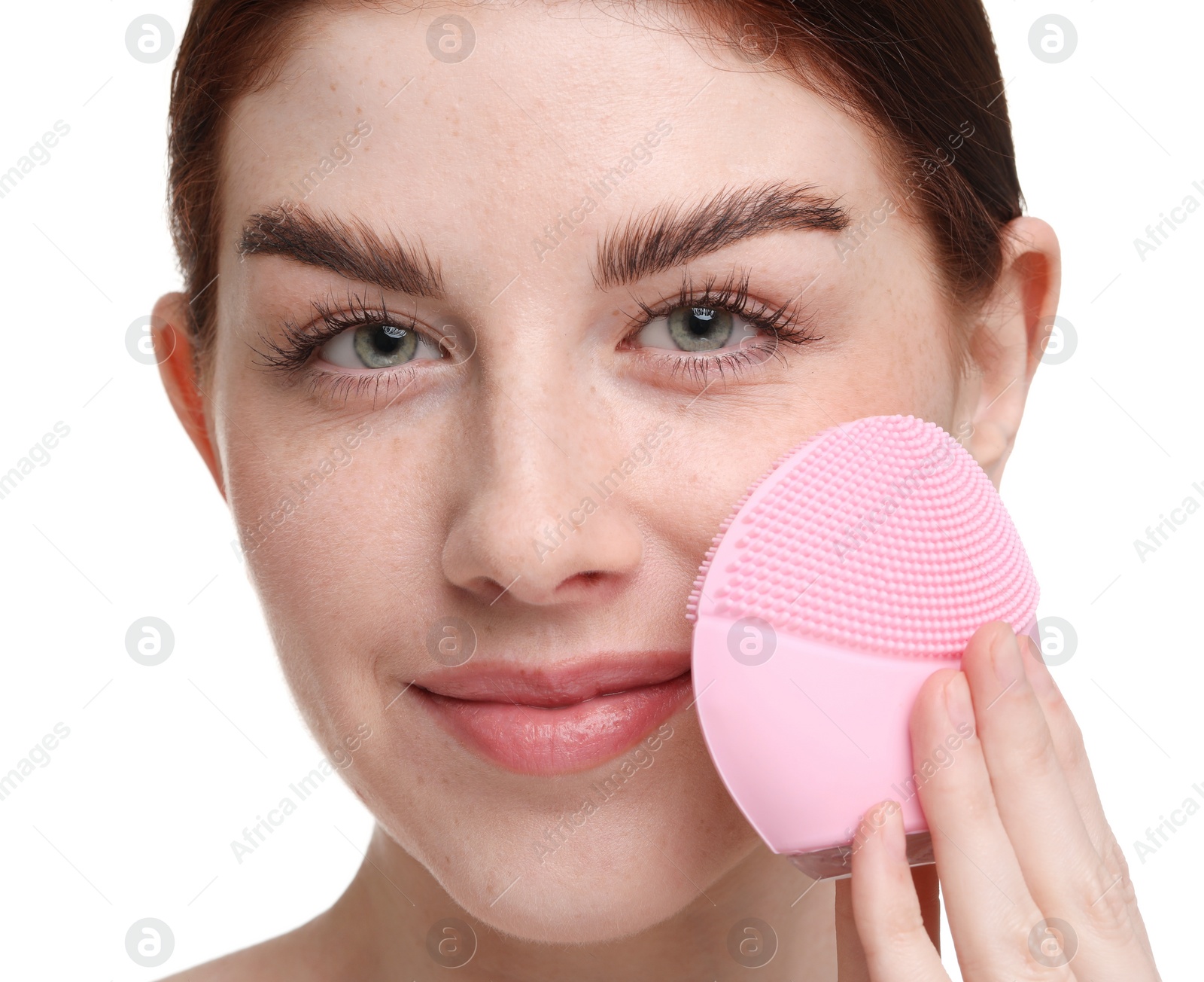 Photo of Washing face. Young woman with cleansing brush on white background, closeup