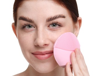 Photo of Washing face. Young woman with cleansing brush on white background, closeup