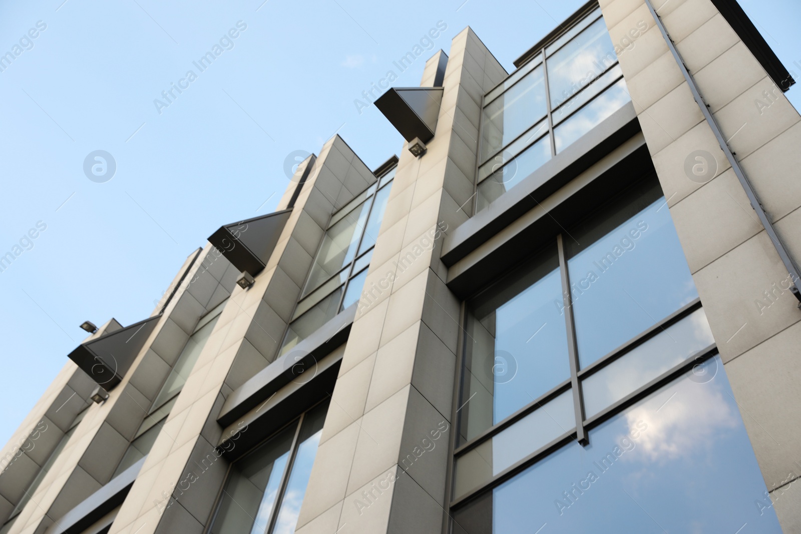 Photo of Modern office building with tinted windows on sunny day