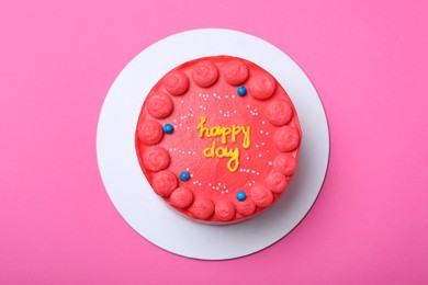 Photo of Cute bento cake with tasty cream on pink background, top view
