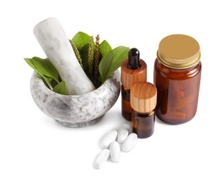 Photo of Mortar with fresh green plantain leaves, extracts and pills on white background